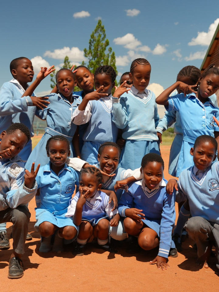 Schoolchildren laughing together outside their school